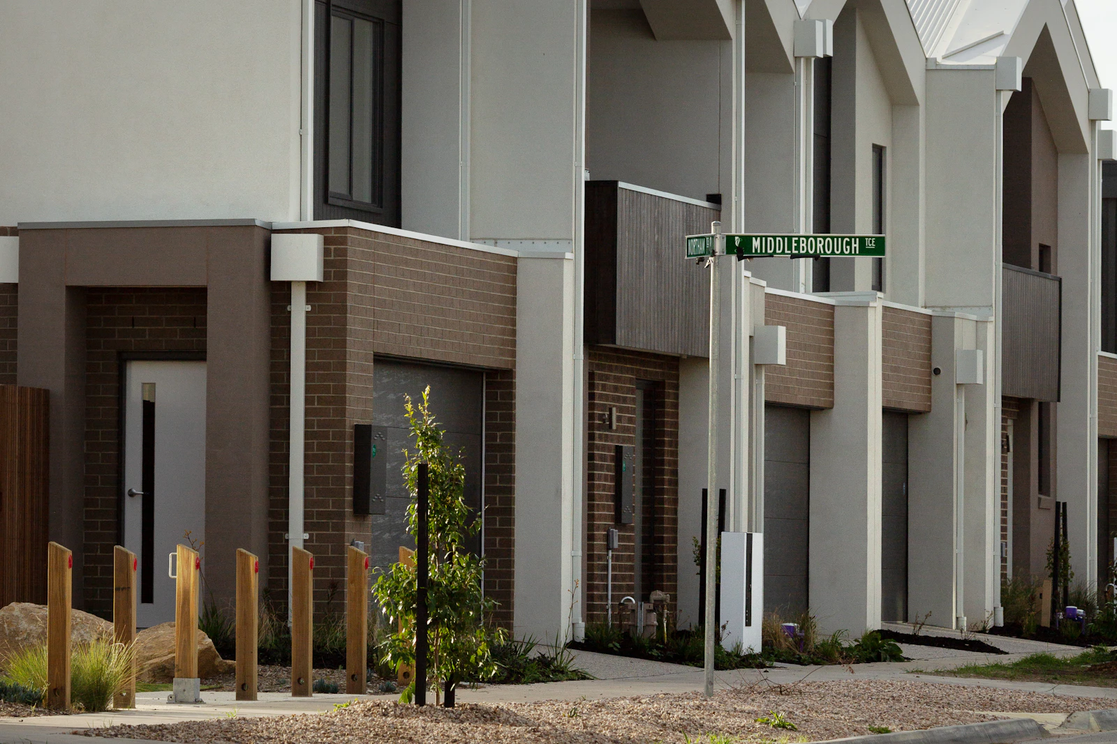 Row of contemporary detached houses with pitched roofs